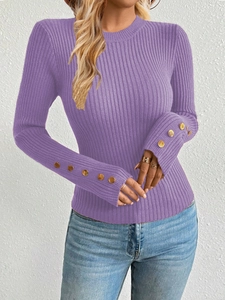 Close-up of purple ribbed knit sweater showing decorative gold buttons on sleeves