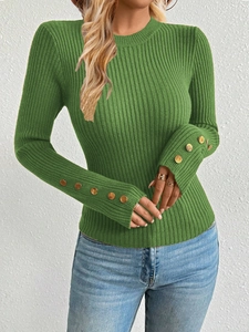 Close-up of grass green ribbed knit sweater featuring golden buttons on wide cuffs