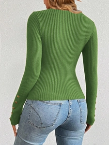 Detail of green ribbed knit sweater with gold buttons on the sleeve and vertical texture