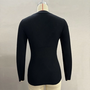 Detailed back view of a black slim-fit ribbed knit top with vertical texture on a mannequin
