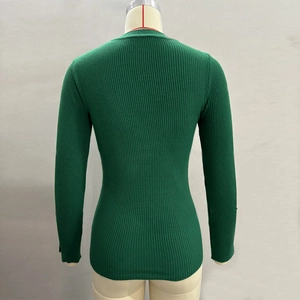 Close-up of emerald green ribbed knit sweater back view on a mannequin torso