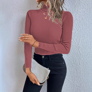 Detail of dusty rose turtleneck knit top showing the ribbed texture and slim fit design
