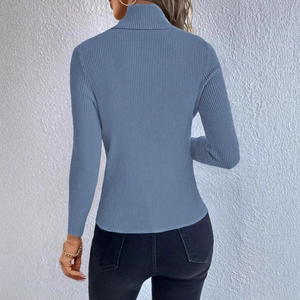Close-up detail of the vertical ribbed texture and high collar on a slim-fit knit sweater
