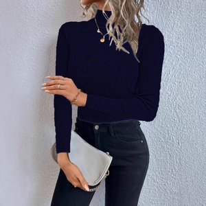 Close-up of dark blue ribbed turtleneck sweater showing fine knit fabric texture