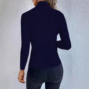 Detail view of navy blue ribbed knit texture and turtleneck design on a slim-fit sweater