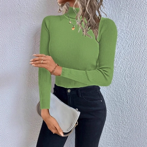Detail of mock neck ribbed knit top in grass green with elastic long sleeve texture