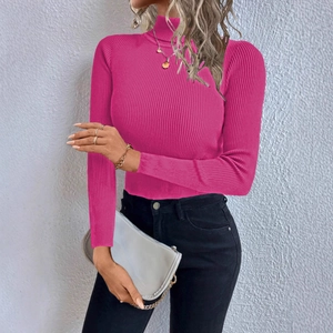 Detailed view of bright pink turtleneck knitwear with vertical ribbed texture and slim fit