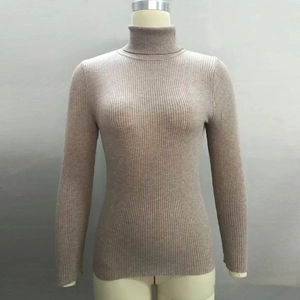 Detailed view of the vertical rib-knit texture and turtleneck design on oatmeal sweater