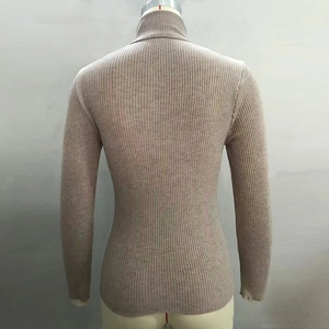 Detail of high neck ribbed knit sweater showing back silhouette in light tan finish
