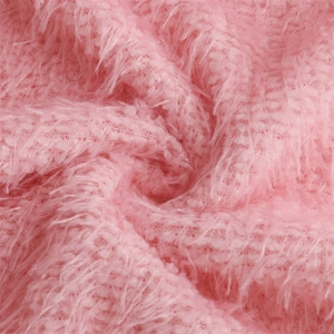 Close-up of soft pink long-pile faux fur fabric texture of the knit sweater dress