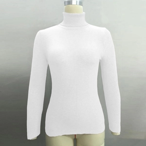 Close-up of white ribbed turtleneck knit sweater showing soft slim-fit texture