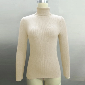 Detail of ribbed knit texture on a beige turtleneck sweater with fitted design