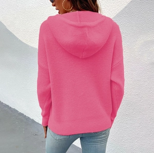 Rear view of pink chunky knit hooded cardigan sweater with detailed texture and draped sleeves