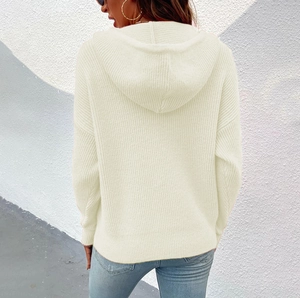 Detail view of beige cable-knit hooded cardigan featuring a relaxed fit and back texture