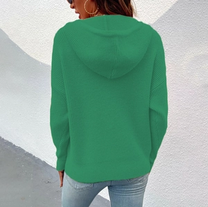 Detailed view of the emerald green knitted hoodie featuring vertical ribbed textures