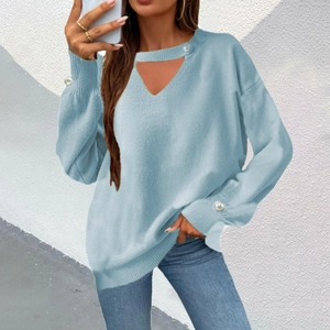 Detail of light blue V-neck knit sweater with hollow collar and pearl beads on cuffs