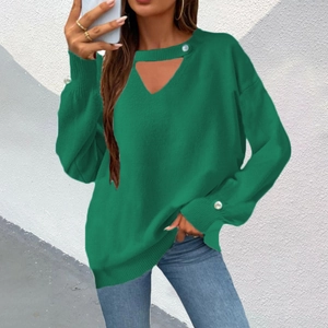 Detail of dark green knit sweater featuring a V-neck cutout and white pearl button accents