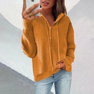 Detail of orange knitted hoodie cardigan featuring matching buttons and drawstring texture