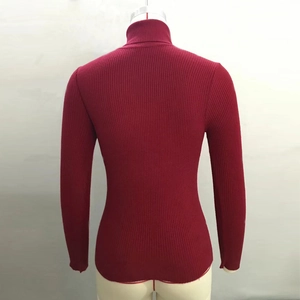 Detail of burgundy turtleneck sweater featuring vertical ribbed knit texture on the back