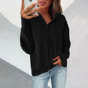 Close-up of black hooded knitted cardigan with buttons and comfortable oversized fit