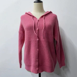 Detail of pink knitted hooded cardigan featuring ribbed texture and button closure