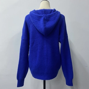 Back view of a Klein blue cable knit hooded cardigan showing ribbed cuffs and textured hem