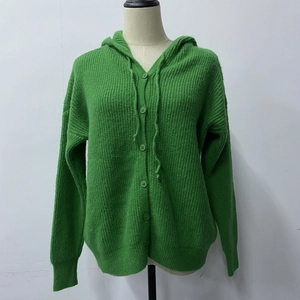 Detail of green ribbed knit hoodie cardigan with buttons and matching drawstrings