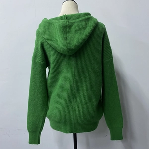 Back view of grass green hooded cardigan showing thick knit texture and ribbed hem