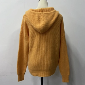 Detailed back view of a ginger yellow hooded knit cardigan with ribbed texture and soft fabric