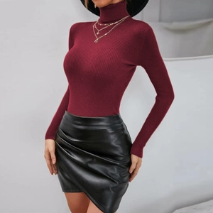 Close-up of wine red turtleneck knit top with slim ribbed texture and black faux leather skirt