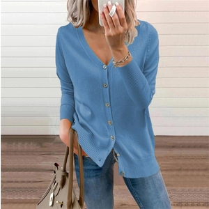 Detail of blue V-neck cardigan featuring ribbed cuffs and a classic button-down closure