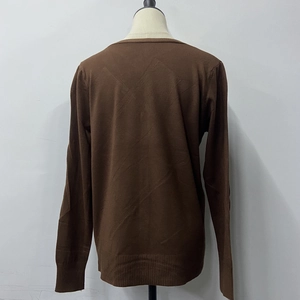 Detail of the ribbed texture on the back neck and hem of this dark brown knit sweater