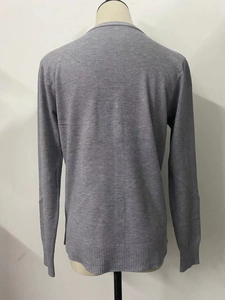 Detailed back view of a grey knit cardigan showing ribbed hem and smooth sleeve texture