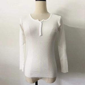 Close-up of white ribbed knit fabric with buttoned round neckline detail on a slim fit sweater