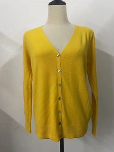Detailed view of yellow V-neck knit cardigan sweater with six buttons and ribbed cuffs