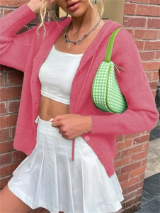 Detail of rose pink buttoned knit cardigan sweater with ribbed texture and drop shoulder