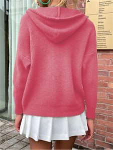 Back view of pink chunky knit hooded cardigan with textured fabric and oversized fit