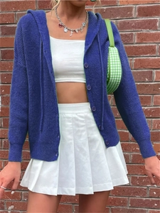 Detail of blue hooded knit cardigan showing vertical rib texture and button closure