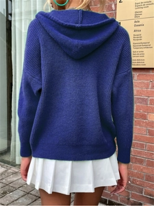 Rear view of navy blue hooded knit cardigan with ribbed texture and pleated skirt