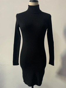 Detail of black ribbed knit dress featuring a classic turtleneck and slim-fit long sleeves