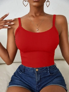 Detail of red ribbed knit tank top fabric with thin straps and heart jewelry