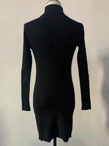 Macro detail of black rib-knit fabric texture on a slim-fit turtleneck sweater dress