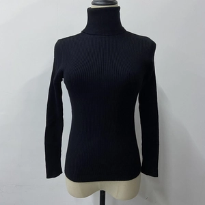 Detail of black long sleeve turtleneck ribbed knit sweater with a slim fit silhouette