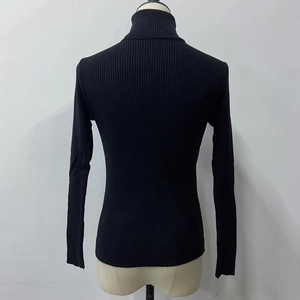 Detailed back view of a black turtleneck sweater with a sleek vertical ribbed knit texture