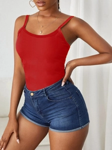 Close-up of a women's red ribbed camisole top paired with classic blue denim shorts