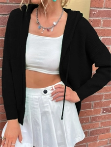 Close-up of black hooded knitted cardigan with waffle texture and button detail