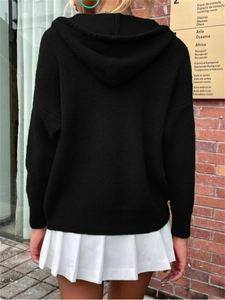 Back view of a black hooded knit cardigan featuring drop shoulders and ribbed cuffs