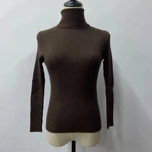 Detail of dark brown turtleneck rib-knit sweater showing the fine fabric texture