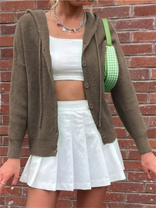 Detailed knit texture of a brown hooded cardigan with round buttons on a model