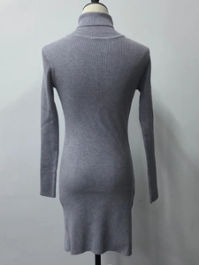 Detail of grey turtleneck knitted dress with elastic vertical ribbed texture and slim fit